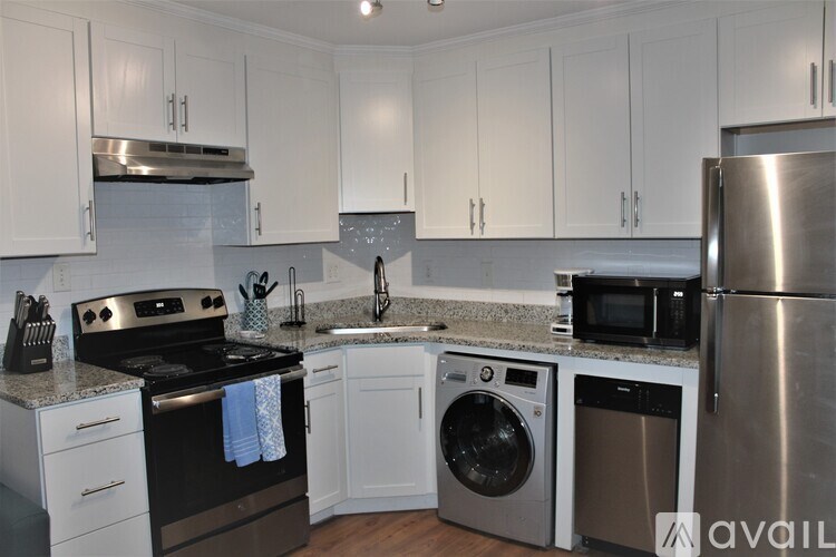 A kitchen with white cabinets and stainless steel appliances.