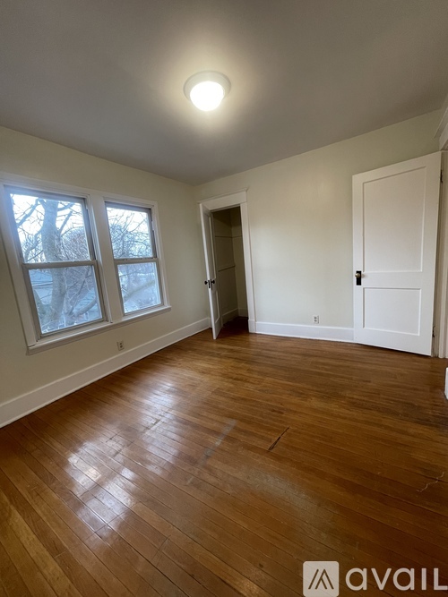 A room with wooden floors and white walls.