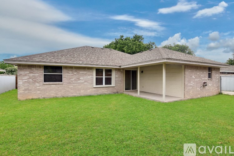 A house with a fenced yard is for sale.