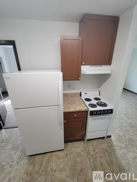 A kitchen with a white fridge and a white stove top oven.