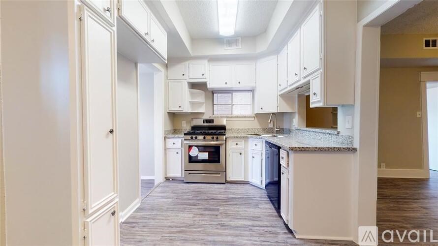 A kitchen with a stove top oven and a dishwasher.