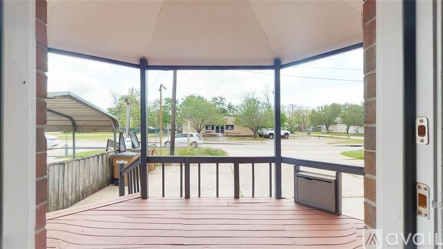 A wooden deck with a bench and a mailbox is visible through a glass door.