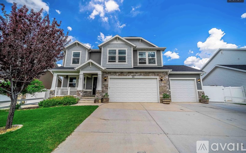 A house with a grey roof and a white garage door.