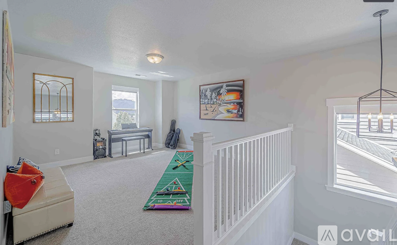 A living room with a white couch and a rug.