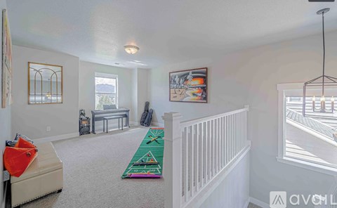 A living room with a white couch and a rug.