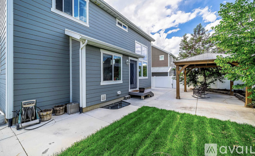 A house with a grey exterior and a covered patio area.