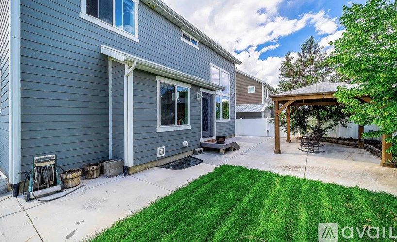 A house with a grey exterior and a covered patio area.