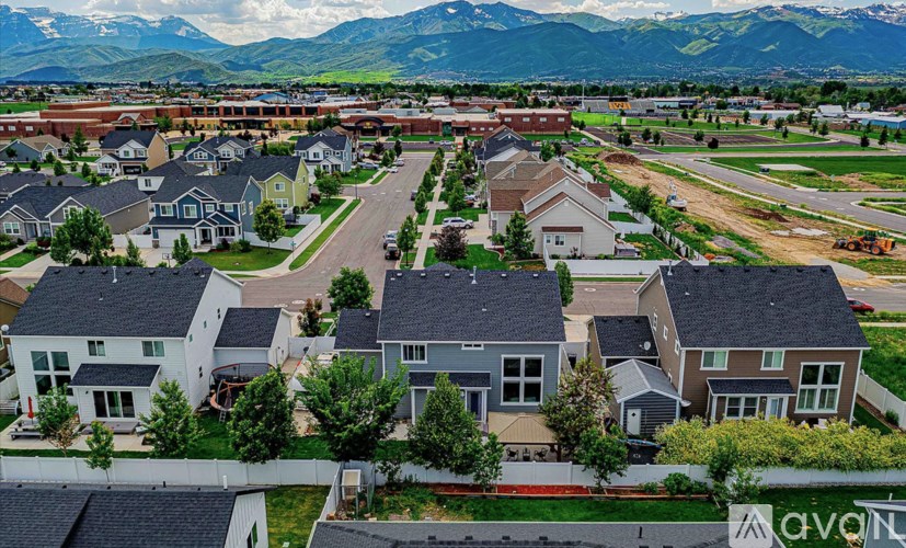 A suburban neighborhood with houses and a mountain range in the background.