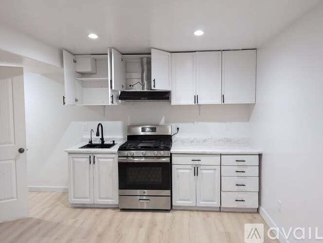A kitchen with white cabinets and stainless steel appliances.