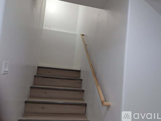 A staircase with wooden steps and a handrail.