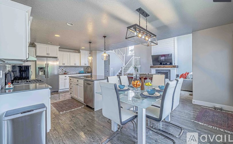 A modern kitchen with a dining table set for four.