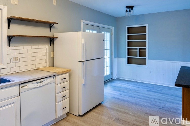 A kitchen with a white refrigerator, white dishwasher, and white oven.