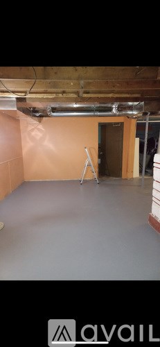 A room with a wooden ceiling and a white wall.