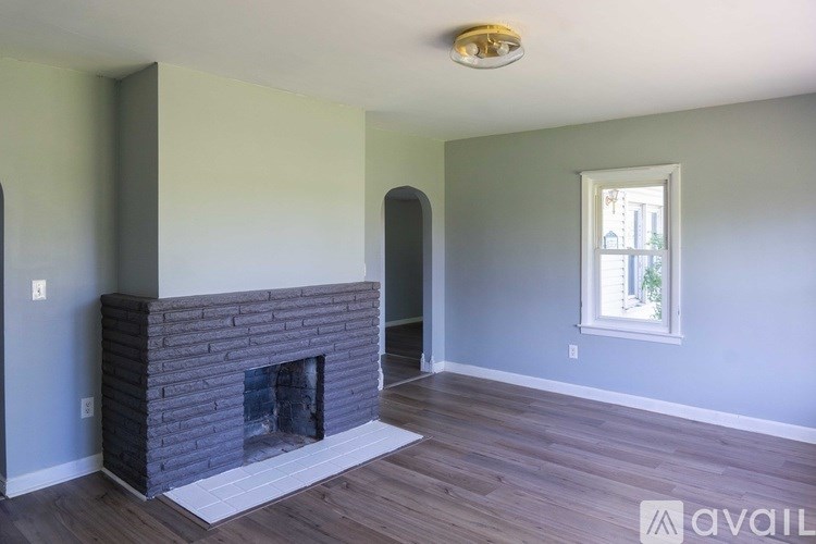 A room with a fireplace and a window.