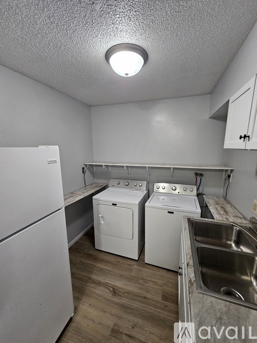 A small laundry room with a washer and dryer.
