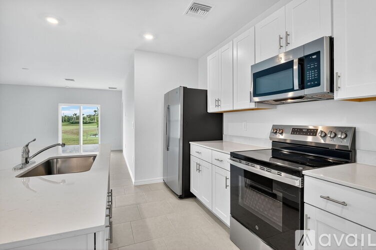 A bathroom with a white toilet, a white sink, and a white bathtub.