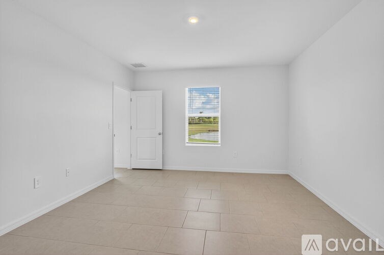 A room with a ceiling fan and a door.