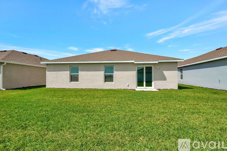 A house with a green lawn in front of it is for sale.