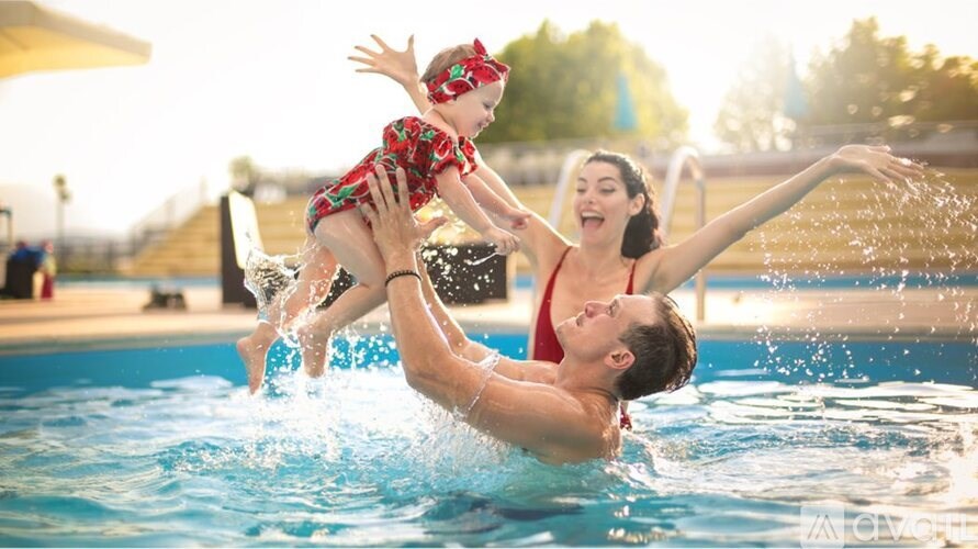A woman and a child are playing in a pool.