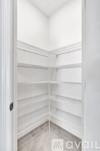 A white pantry with shelves and a door.