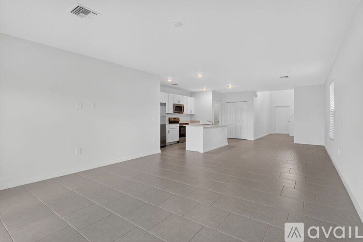 A room with a ceiling fan and a window with blinds.