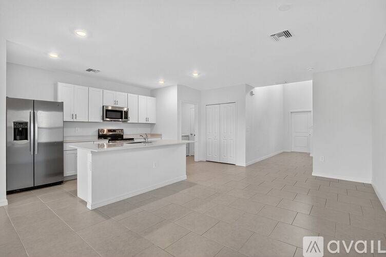 A room with a ceiling fan and a window with blinds.