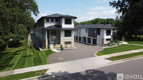 A modern house with a large front yard is for sale.