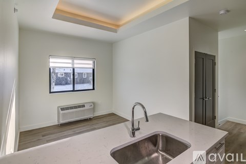 A kitchen with a sink and a window with a view of a snowy landscape.