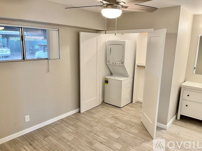 A room with a white cabinet and a white sink.
