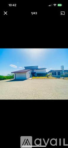 A building with a blue roof and white walls is shown in the image.