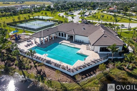 A house with a pool and tennis court.