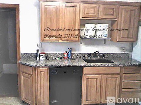 A kitchen with wooden cabinets and a sink.