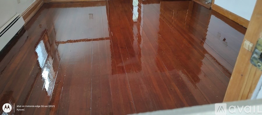 A wooden floor with a dark stain is shown.