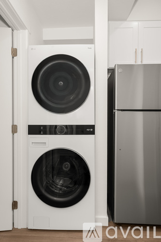 A white washing machine and dryer in a kitchen.