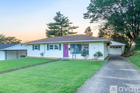 A house with a driveway leading to the garage.