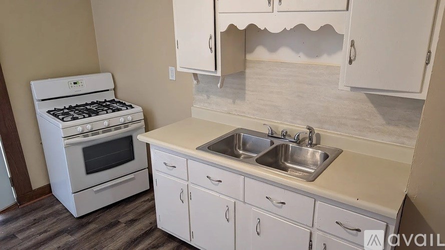 A white stove and sink in a kitchen.