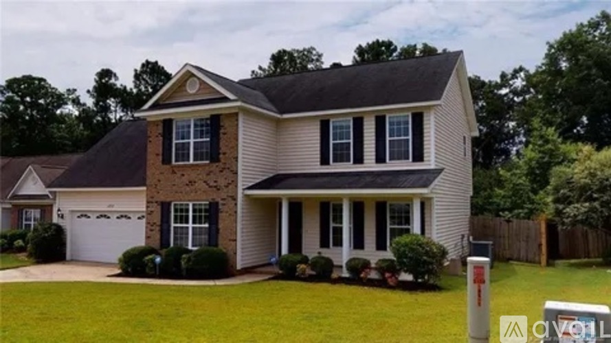 A house with a brown brick facade and a grey roof.