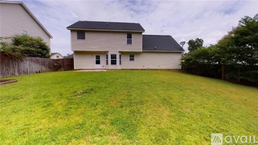 A house with a large lawn in front of it is for sale.