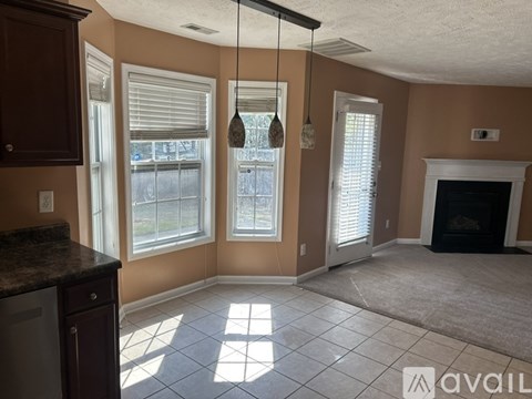 A kitchen with brown cabinets and a black countertop.