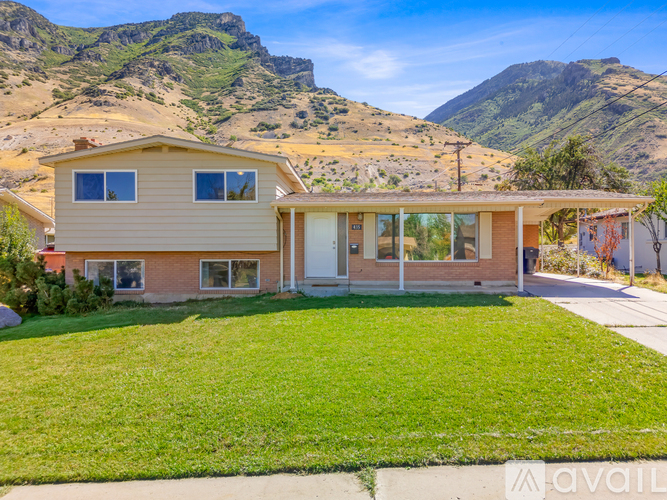 A house with a mountain in the background is for sale.
