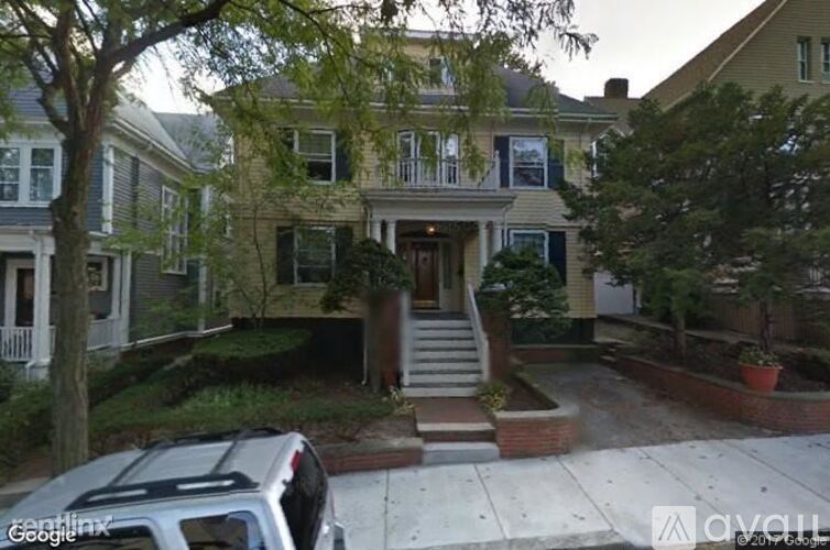 A house with a car parked in front.