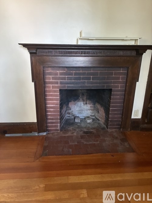 A fireplace with a fire burning inside.