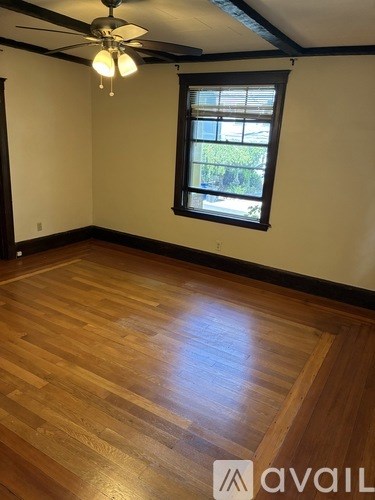 A room with a wooden door and a white wall.