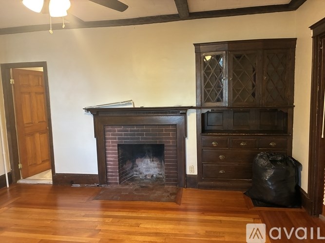 A room with a fireplace and a wooden floor.