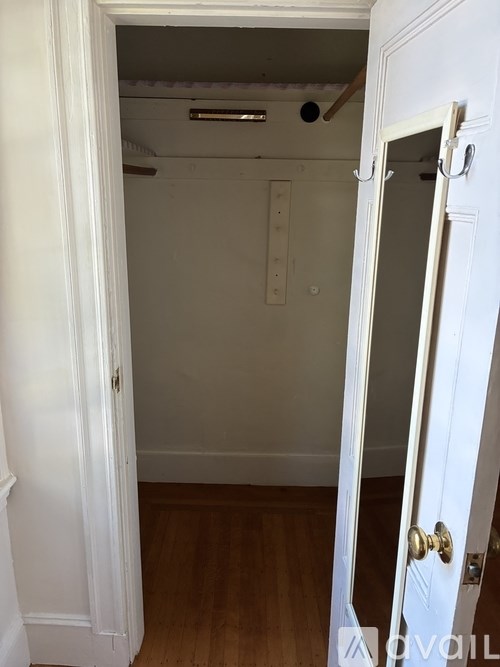 A kitchen with black appliances and wooden cabinets.