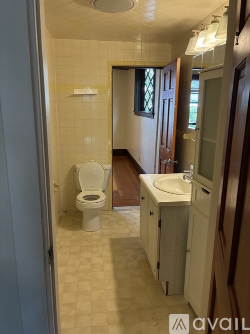 A room with a wooden floor and a ceiling fan.