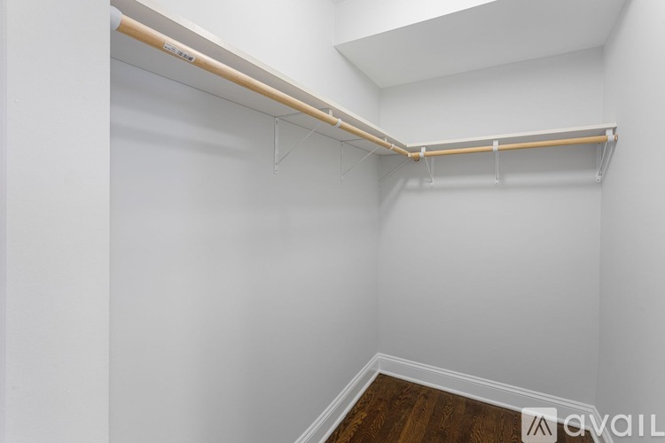 A white wall with a wooden shelf on top.