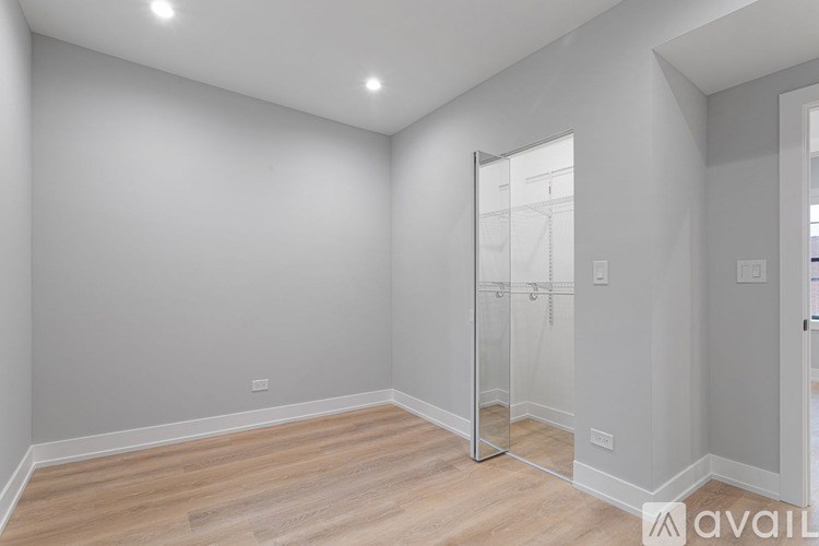 A room with wooden flooring and a glass door.