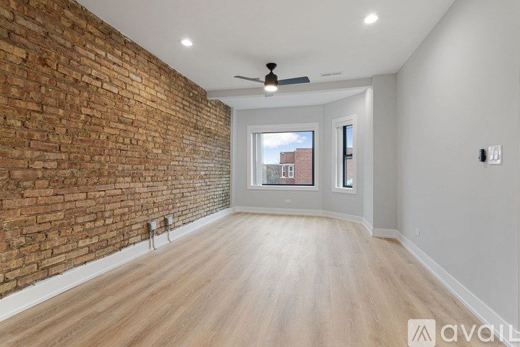 A room with a brick wall and wooden flooring.