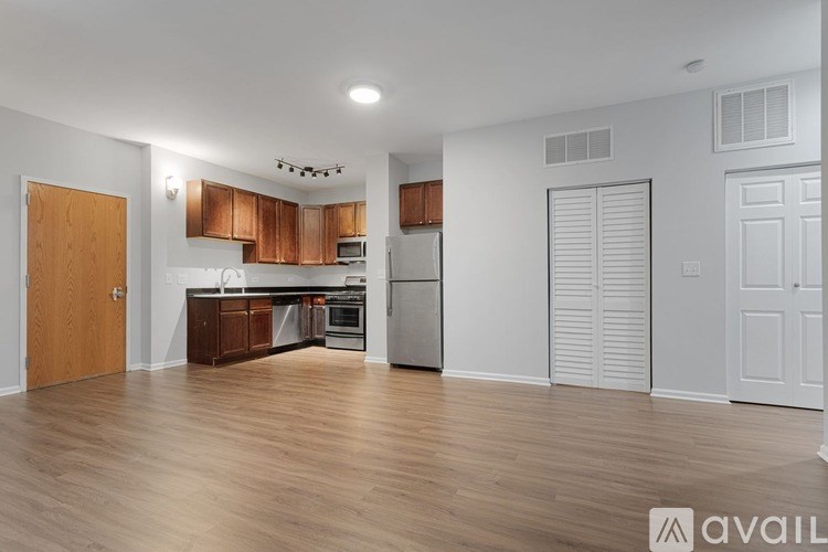 A kitchen with wooden cabinets and a white refrigerator.